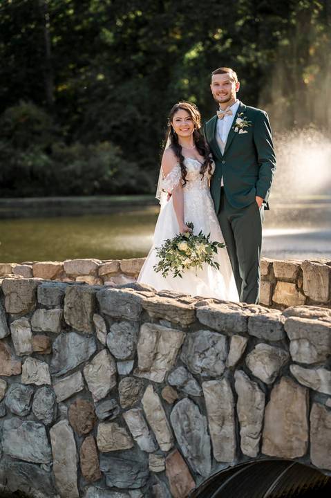 The newlyweds walking hand-in-hand across the beautiful Aqua Turf Club grounds in Plantsville, CT. Perfect backdrop for a summer wedding.'