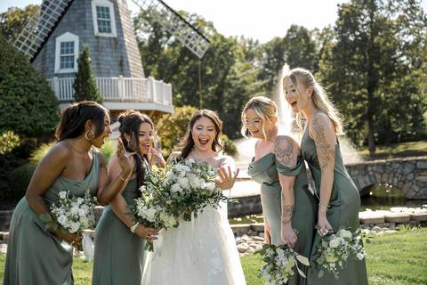 Kiara and her amazing bridesmaids sharing a laugh! Joy and excitement before the Aqua Turf chapel ceremony. Perfect candid moment.'