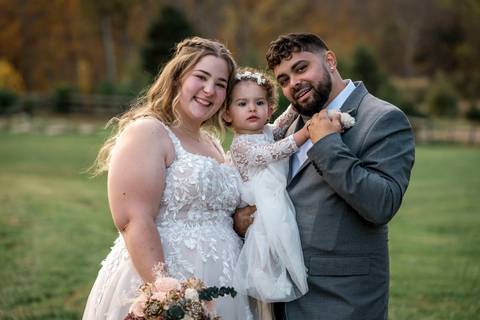 Bride and groom sharing a sweet moment with their daughter at Nuzzo’s Farm by Vanessa Trettel, CT Wedding Photographer serving NY'