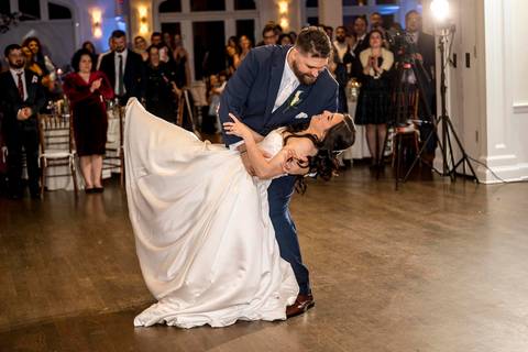 Wide angle shot of the first dance showcasing the grand ballroom architecture at Whitby Castle, reception photography by Vanessa Trettel Photography.'