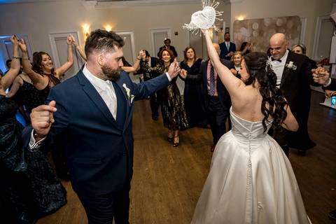 oyful action shot of the Bosnian money dance tradition, capturing the energy and culture in Rye NY, photo by Vanessa Trettel Photography.'