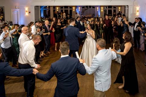 Nick and Emina dancing surrounded by money, a fun and unique Bosnian wedding moment captured by NY Wedding Photographer Vanessa Trettel Photography.'