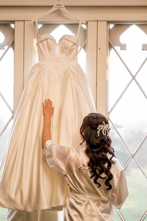 Stunning portrait of Emina in her wedding gown, utilizing soft window light inside the Whitby Castle bridal suite, photo by Vanessa Trettel Photography.'