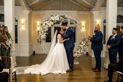 The romantic first kiss as husband and wife! A beautiful ceremony conclusion at Whitby Castle captured by Vanessa Trettel Photography.'