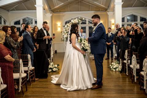 Joyful recessional as Nick and Emina walk back down the aisle smiling, married at Whitby Castle in Rye NY, photo by Vanessa Trettel Photography.'