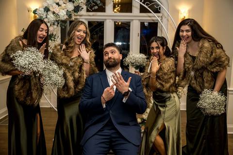 Fun and stylish bridal party group photo with bridesmaids and groomsmen inside Whitby Castle, composition by Vanessa Trettel Photography.'