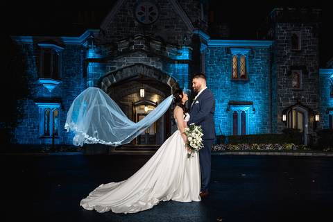Dramatic blue hour wedding portrait outside Whitby Castle using creative off-camera flash, masterpiece night photography by Vanessa Trettel Photography.'