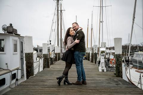 Moody portrait of the couple standing in front of a vintage wooden boat under heavy clouds.
Vanessa Trettel Photography
engagement photo at Mystic CT'