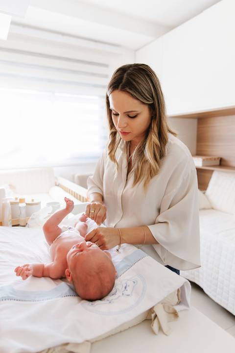 mamãe trocando o newborn para amamentar'