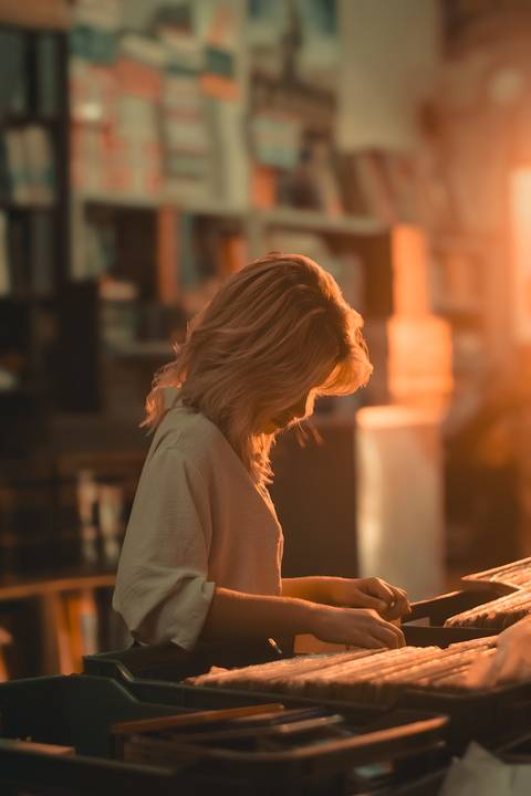 Ensaio fotografico na biblioteca e livraria com livros e discos antigos'