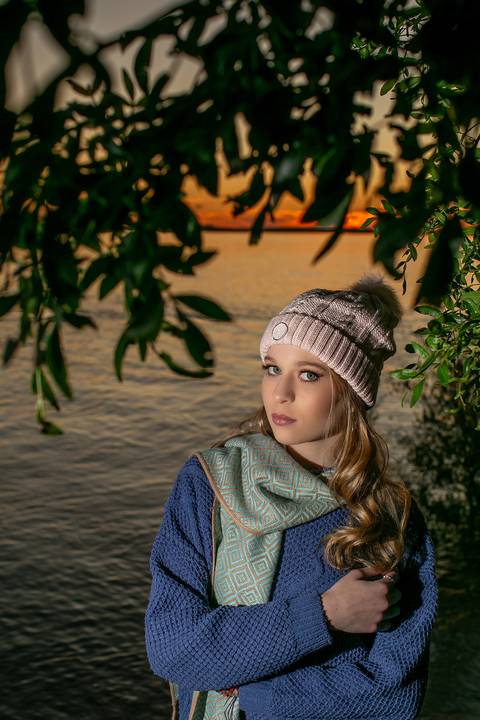 menina calça preta blusa azul com tênis vans ao por do sol na orla do Guaíba com toga bege e cachecol. Fábio Martins fotografo '