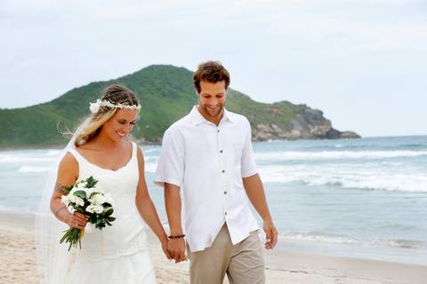 noiva-beijando-noivo-casal-se-beijando-na-praia-noiva-chegando-ao-altar-na-beira-da-praia-convidados-vestimenta-festa-casamento-na-beira-da-praia-do-rosa-sal-e-mar-making-of-noivo-se-arrumando-para-o-casamento-na-praia-do-rosa-em-santa-catarina-fotografia'