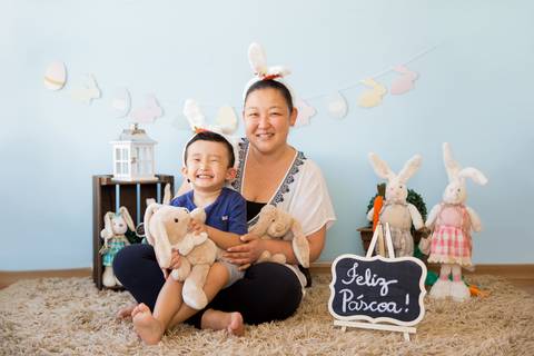 foto de criança com família no cenário decorado com coelhos. mini ensaio fotografia páscoa '