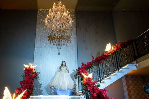 Entrada da debutante na escadaria da Casa Bertolazzi Santana, com lustre de cristal, foto por fotógrafo de festa de 15 anos em SP.'