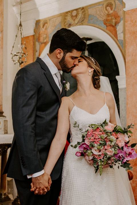 Noivos se beijando no altar'