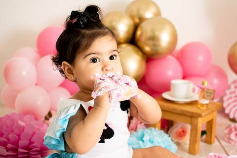 alice comendo o bolo do smash dela realizado no estudio amora com baloes rosa'