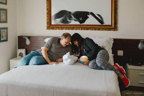 Retrato de pais olhando para o bebê na cama'