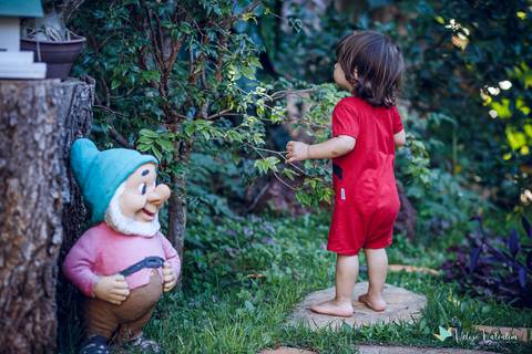 criança em jardim com um anão'
