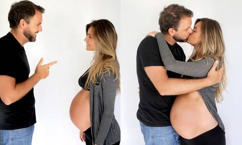 casal em ensaio fotográfico, homem com camisa preta e calça jeans, mulher com top e calça preta com casaco cinza.'