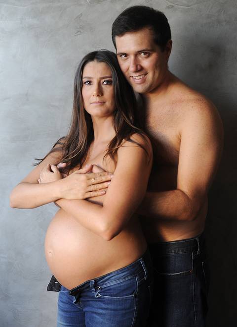 casal abraçado, usando calça jeans.'