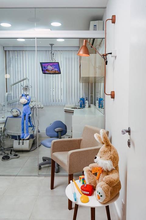 Vista da estação de trabalho e cadeira odontológica em consultório que investe em tecnologia e imagem profissional.'