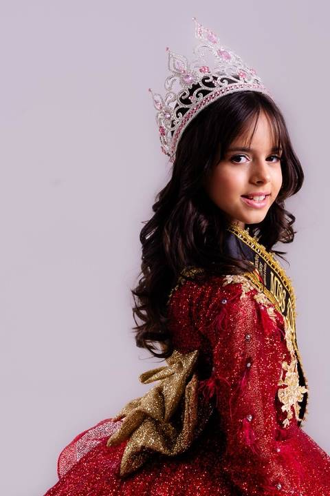 etrato oficial de Miss Kids com coroa Close de beleza (headshot) da Miss Kids destacando a maquiagem profissional para concurso. Direção técnica para realçar a expressividade e o carisma.'