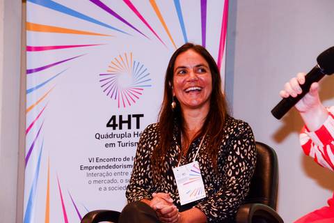 Close profissional de palestrante durante evento de inovação e turismo no Rio de Janeiro.'