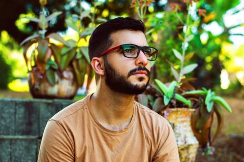 Ensaio masculino externo com livros e violão Agência Cricaré'