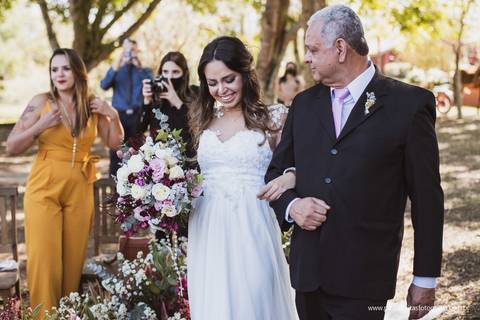 noiva se emociona na estrada da cerimonia com seu pai'