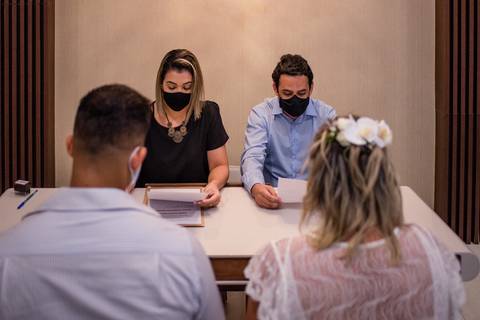 Momento da leitura da certidão de casamento realizada no cartório de laranjeiras, serra, es. Fotografia de casamento no cartorio'