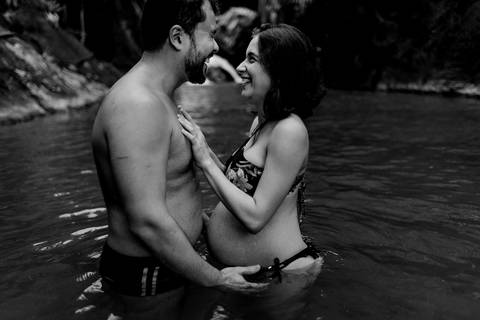 Fotografia preto e brando do momento em que ela coloca a mão no peido dele. Devido a agua estar gelada ele fez uma expressão bem forte. Os dois gargalharam juntos e a fotografia foi feita.'
