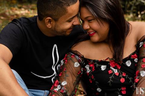 Foto de casal espontâneo se amando sentados na grama'