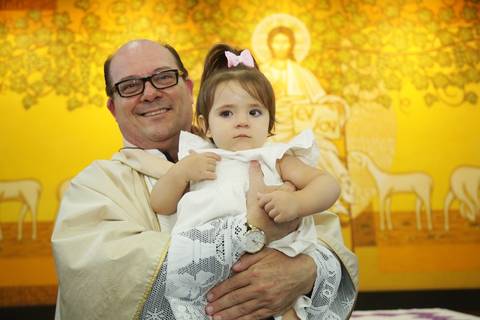 fortos batizado no altar da igreja: com padre e família, pais, padrinhos, avós, tios '