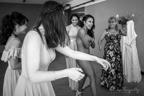 Sensual novia mostrando su cuerpo con las damas de honor y la madrina en el getting ready. Preparadas para el casamiento.'