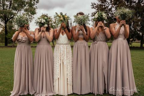 Damas de honor con ramo de novia. Vestido de dama de honor con la novia antes de su casamiento al atardecer en la estancia.'