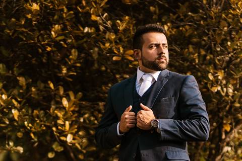 retrato do noiva arrumando o terno'