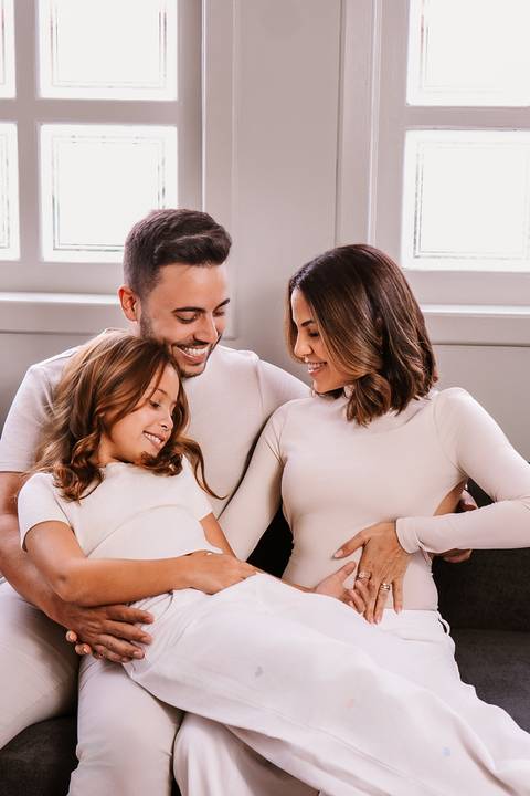 Retrato afetivo de Sarah, Mateus e Malu celebrando o chá revelação em clima de união e alegria.'