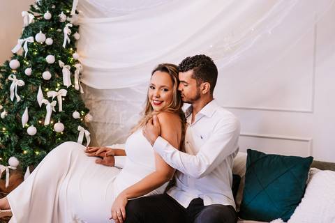 Casal sentado diante da árvore branca em momento sereno.'