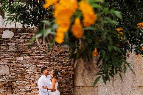 Casal em cenário urbano com natureza durante ensaio pré wedding'
