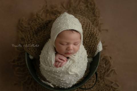 baby sleeping in a bucket'
