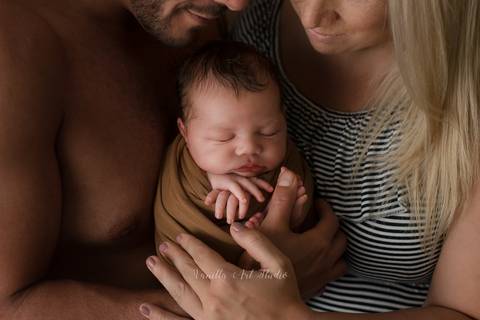 mummy and daddy holding a baby'