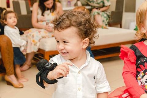 menino brincando com aranha de pelúcia '