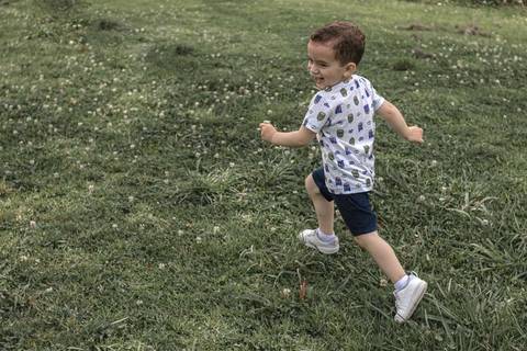 menino correndo  no parque '