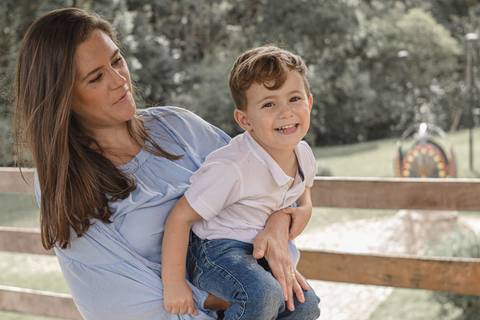 Pai com filho  no colo   no gramado do  Memorial Ucraniano no Parque Tingui '