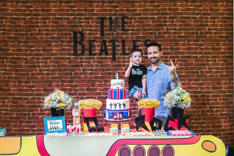 Pai e Filho na mesa da decoração da festa infantil tema Beatles no Buffet Play House  Curitiba'
