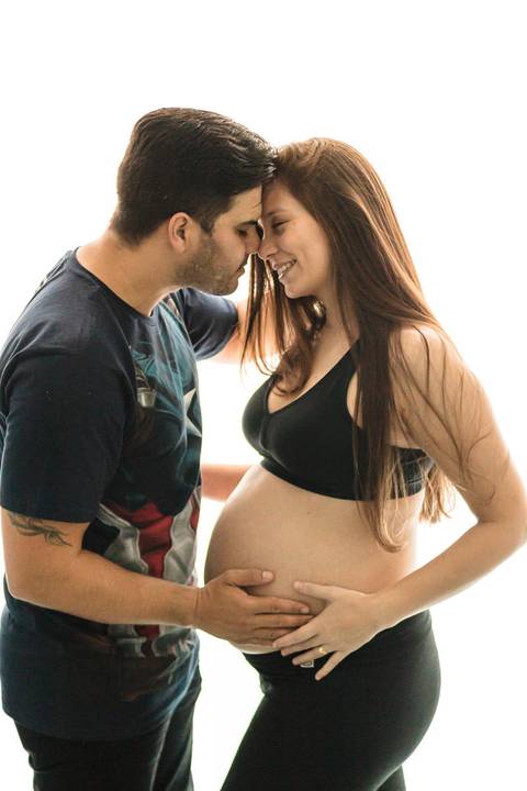 casal grávida abraçados'