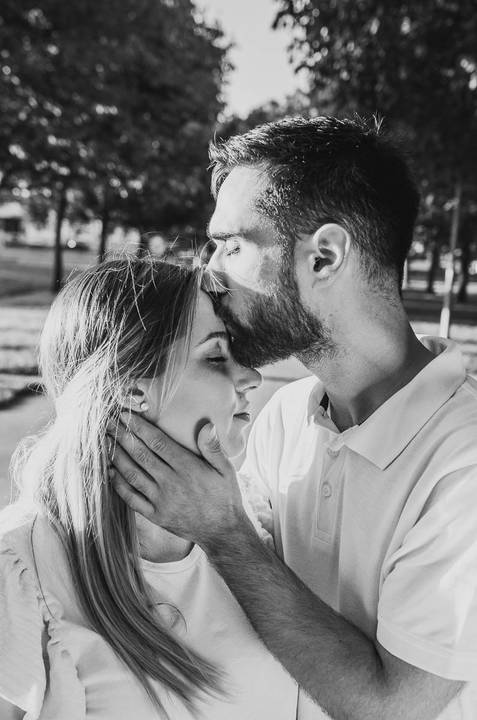 Casal em preto e branco em pose carinhosa no parque'