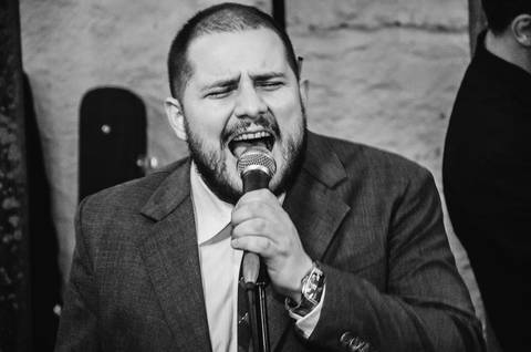 Músico tocando bateria durante festa de casamento Camila e Rafael em São Paulo, banda ao vivo em ambiente escuro'