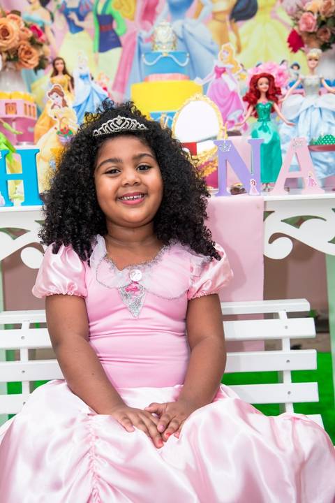 criança sorrindo, feliz ao ver a decoração da festa infantil em sao paulo no tema das princesas, vestido de princesa'