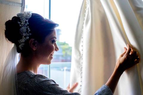 Mirada tierna de la novia al observar su vestido, capturando emociones, en santa cruz por luis arnez'